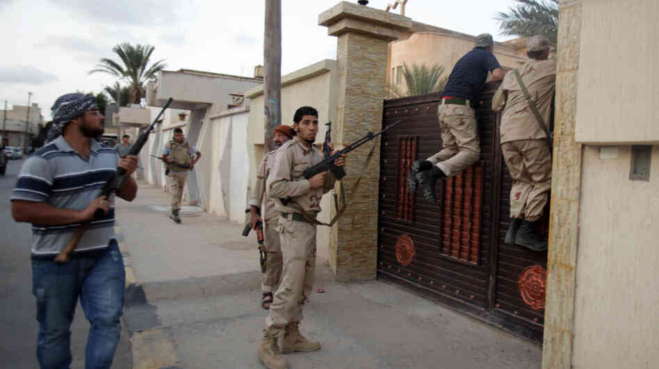 Libyan rebel fighters raid a house in Tripoli on Tuesday as they search for supporters of ousted leader Moammar Gadhafi. The rebel leadership is trying to get various rebel factions to work together to create a new government and security force. Libyan rebel fighters raid a house in Tripoli on Tuesday as they search for supporters of ousted leader Moammar Gadhafi. The rebel leadership is trying to get various rebel factions to work together to create a new government and security force.